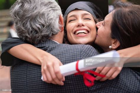 Proud Parents Hugging Their Daughter And Celebrating Her Graduation