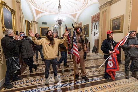 adam johnson who allegedly stole pelosi s lecturn jake angeli charged in capitol riots the
