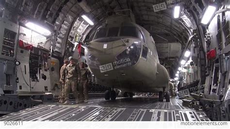 Loading A Ch 47f Chinook Into A C 17 Globemaster Aircraft Stock Video