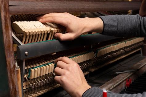 Premium Photo Closeup Of Hand And Tools Of Tuner Working On Grand Piano