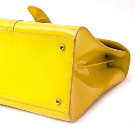 To ship orders to your current location please. Delvaux Limited Patent Fluorescent Yellow Brillant closure ...