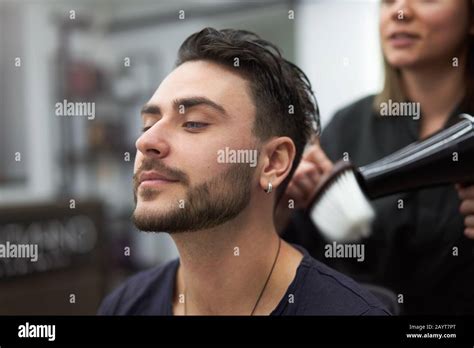 Stylish Man Sitting Barber Shop Hairstylist Hairdresser Woman Blow Dry