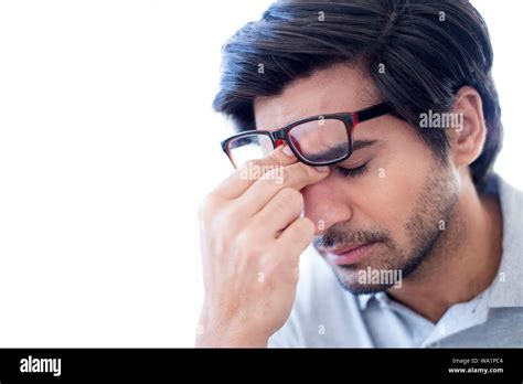 Man Pinching The Bridge Of His Nose Wearing Glasses Stock Photo Alamy
