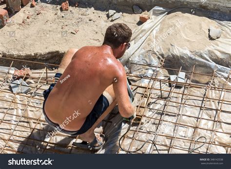 Naked Worker Angle Grinder On Construction Stock Photo