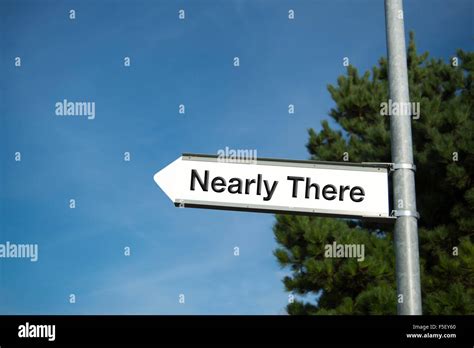 Signpost with 'Nearly There' direction sign Stock Photo: 89453784 - Alamy