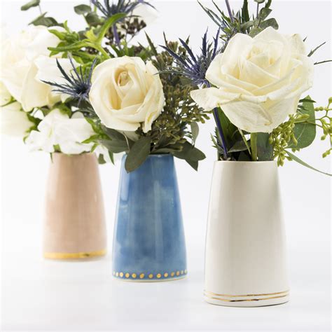 Three Vases With White And Blue Flowers In Them