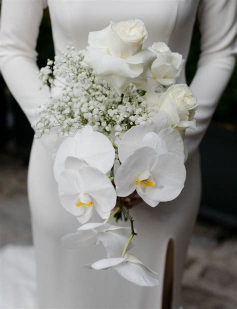 This Bouquet Was Done With White Roses Orchids And Babys Breath