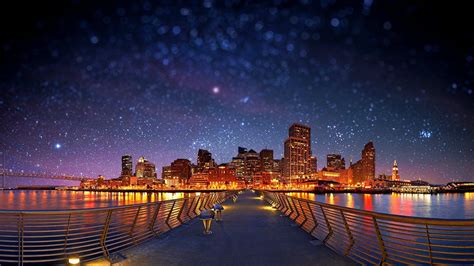 The City Skyline Is Lit Up At Night With Stars In The Sky And Lights