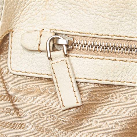 Authenticity card, stitching quality, logos, matching colors throughout, engraved prada name with a curved r, and overall quality materials are all good signs that your product is genuine. Prada White Ivory Leather Vitello Daino Life Italy w/ Authenticity Card For Sale at 1stdibs
