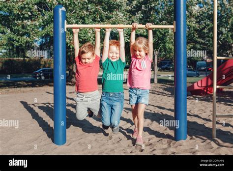Children Hanging On Monkey Bars At Playground Stock Photo Alamy