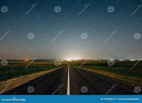 Night Sky With Stars Above The Highway And Corn Fields Stock Photo