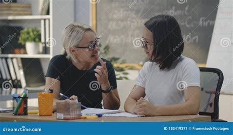 Teacher Explaining To Student In A Classroom Stock Image Image Of