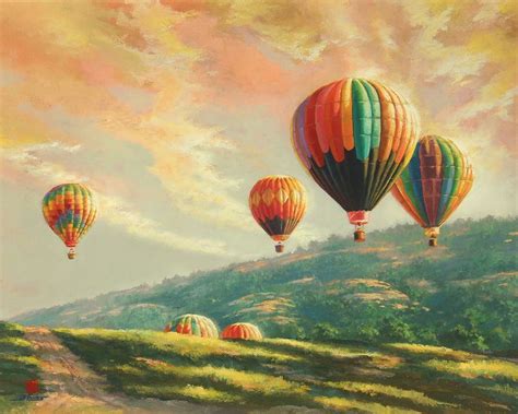 Three Hot Air Balloons Flying In The Sky Over A Field With Hills And
