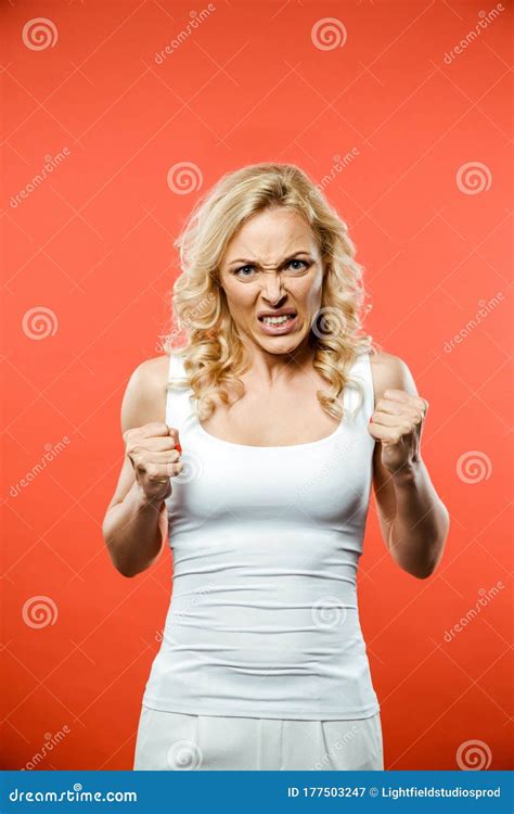 Angry Blonde Woman Looking At Camera And Showing Fists Stock Image
