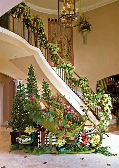 A Staircase Decorated With Flowers And Greenery Next To A Christmas