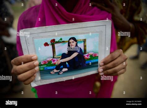 A Bangladeshi Woman Holds A Photograph Of Her Missing Sister At A
