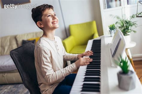 Little Boy Playing Piano In Living Room Child Having Fun With Learning