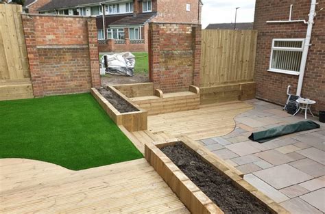 Modern backyard with water features. Indian Sandstone Paving - Decking - LazyLawn Artificial Grass