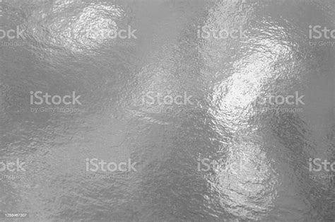 Silver Foil Texture Background With Highlights And Uneven Surface Stock