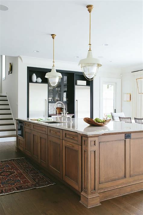 White and black kitchen cabinets already scream classic, but adding some dark wood into the picture takes it a step further. Before You Pick Up That White Paint... Consider These ...