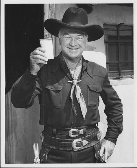 Hopalong Cassidy holding up a glass of milk, ca. 1950 | Wyoming History Day