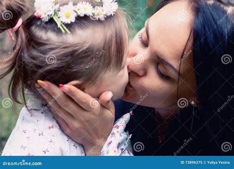 mother kiss her daughter at tropical garden stock image 16577953