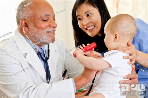 Doctor Examining Baby Boy Stock Photo Picture And Royalty Free Image