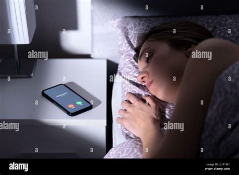 Phone Call By Unknown Caller At Night While Woman Is Sleeping In Bed Scam Fraud Or Mobile Hoax