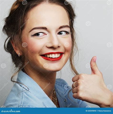 Smiling Beautiful Young Woman Showing Thumbs Up Gesture Stock Photo