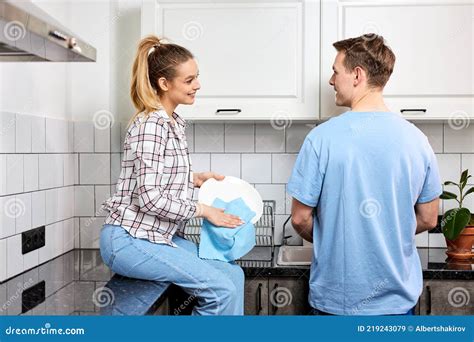 Positive Caucasian Couple Washing Dishes Together Indoors Keeping