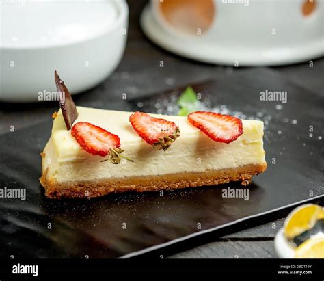 A Slice Of Cheesecake With Strawberry Slices Stock Photo Alamy