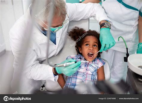 Scared Girl Dentist Repairing Tooth Stock Photo By ©luckybusiness 224974986