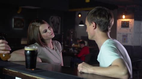 The Girl And The Guy Are Sitting At The Bar Chatting Man Trying To
