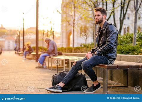 Young Man Sitting On A Bench Stock Image Image Of Jacket Sunlight