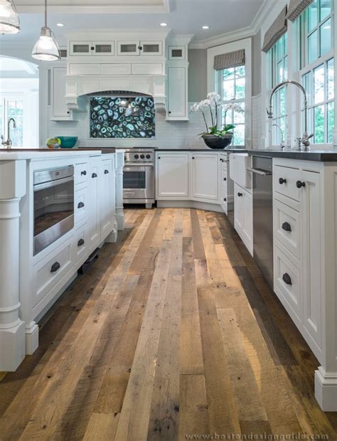 Hardwood floors give homes natural look that is always stylish. Custom wood floors in a white kitchen