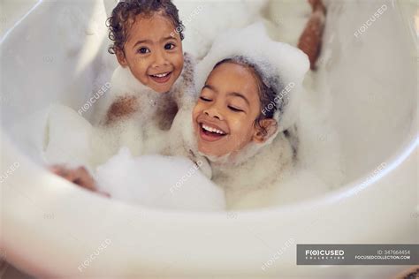 Portrait Playful Sisters Enjoying Bubble Bath — Smiling Responsibility