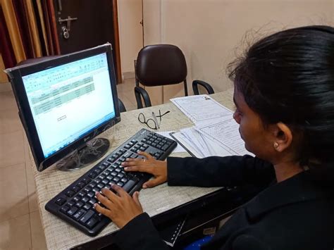 An Indian Female Office Incharge Working On Personal Computer In India