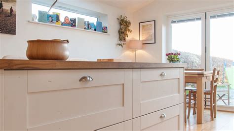 Instead of plain, straight lines, the edges of the cupboards and drawers are curved giving the design a gentle, fluidity. White Shaker Kitchen with Wooden Worktops - Burwash East ...