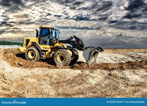 Powerful Bulldozer or Loader Moves the Earth at the Construction Site