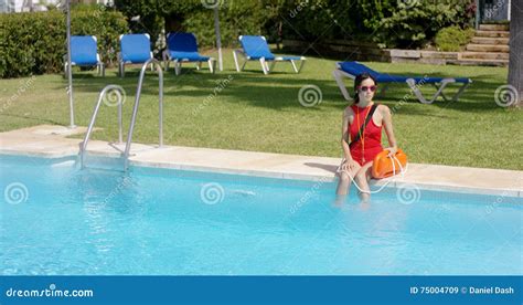 Lifeguard In Red Swimsuit Sitting At Edge Of Pool Stock Image Image