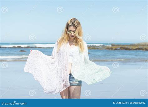 Beautiful Woman Wrapped In Towel And Relaxing In The Beach Stock Photo