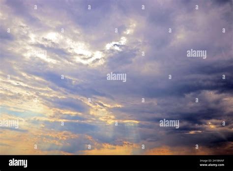 The Suns Rays Break Through The Dark Clouds Stock Photo Alamy