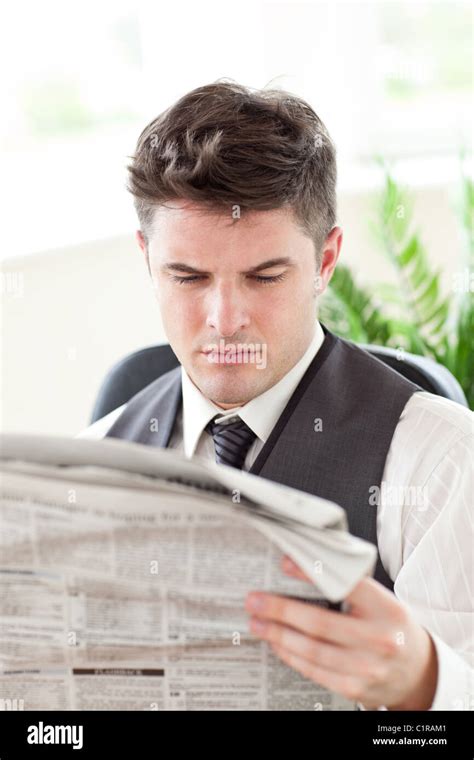 Concentrated Businessman Reading A Newspaper Stock Photo Alamy