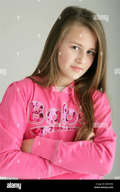 Ten Year Old Girl Wearing A Pink Top And Standing With Her Arms Folded