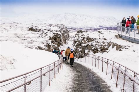 Toursts On Silfra Rift During Winter In Thingvellir National Park
