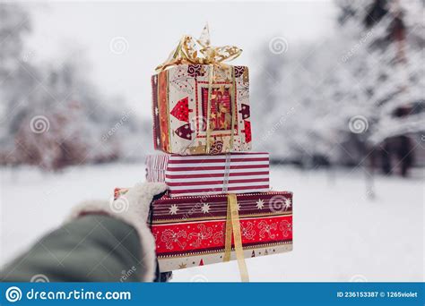 close up of heap of red christmas presents t boxes in snowy winter park outdoors festive