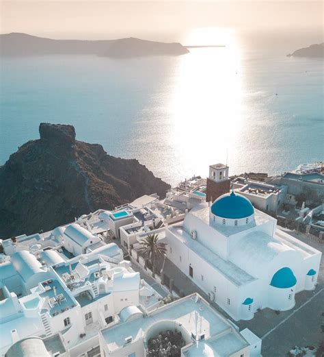 Santorini 🇬🇷 The Iconic White And Blue Buildings Here Are Nestled