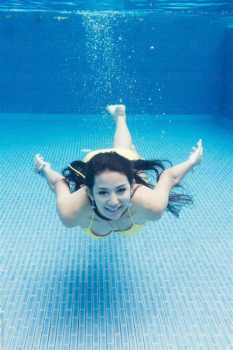 Underwater View Of Woman Diving By Michela Ravasio