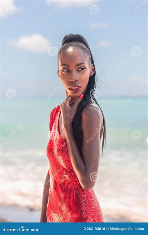 Portrait Of Beautiful Caribbean Adult Teen In Barbados Wearing Red Bikini And Standing On A