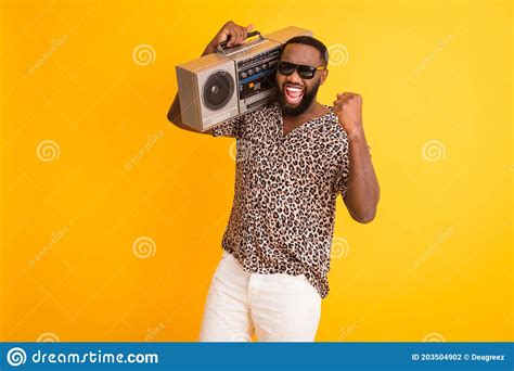 photo of crazy handsome dark skin guy hold shoulder retro tape recorder raise fist cool holidays